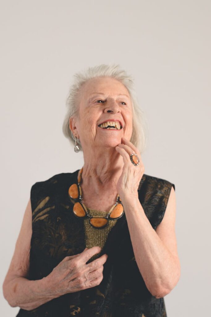A joyful senior woman showcasing her style and elegance with a smile.